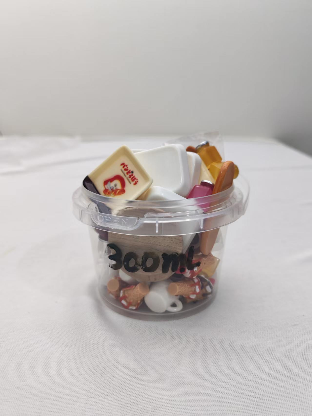 300 milliliter miniature contents shown inside a reference bucket